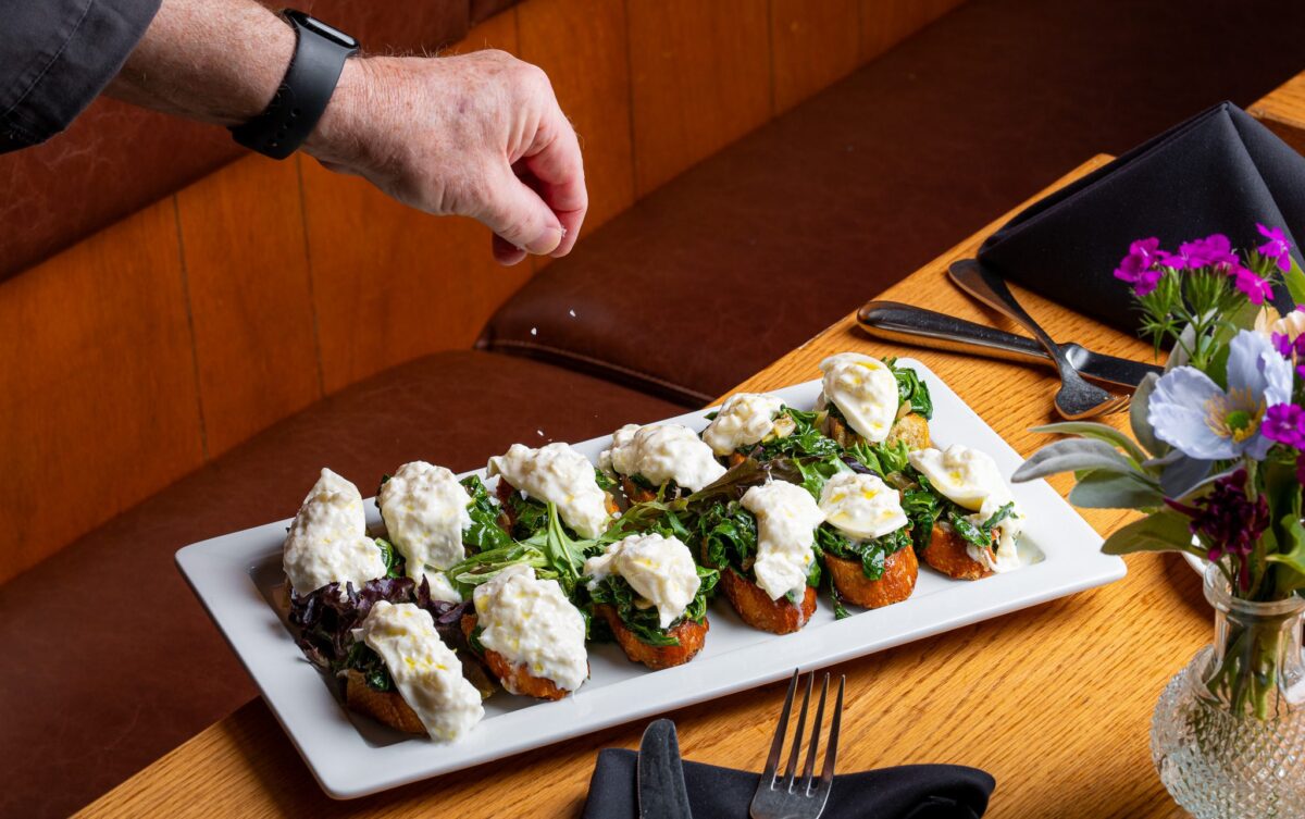 Bruschetta appetizer with a sprinkle of salt