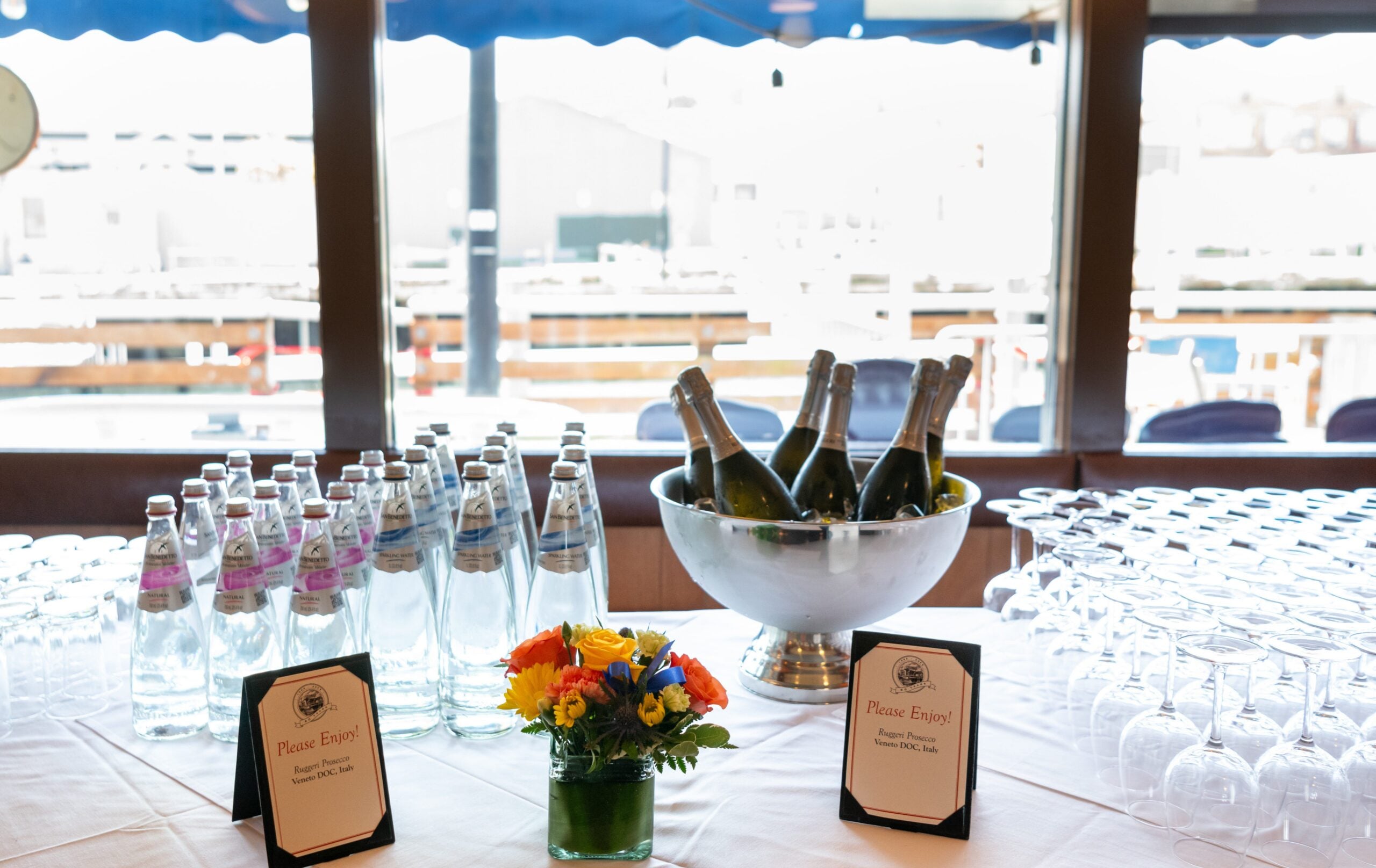 Scoma's 60th Anniversay table with water and Champagne and glasses